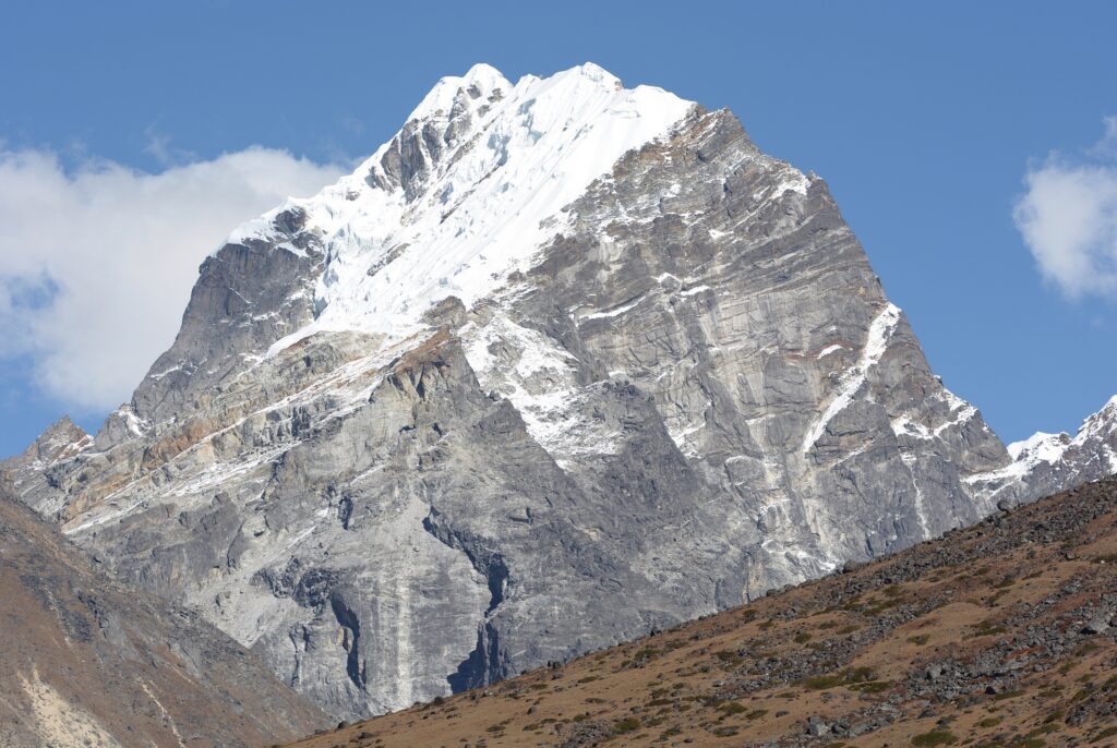 Lobuche East's rocky, snow-capped summit under a blue sky.